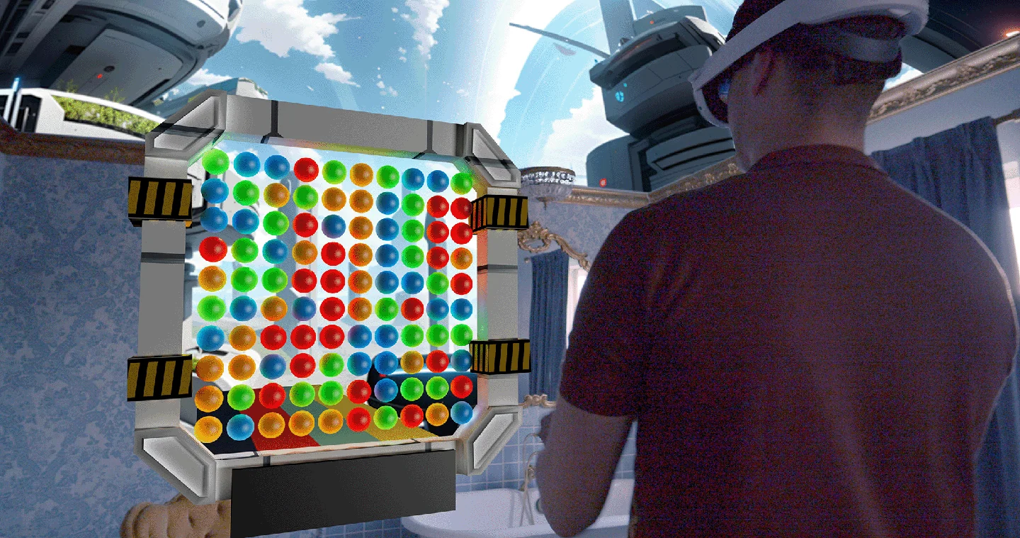 A player wearing a headset beside the Balls To The Wall marble board.